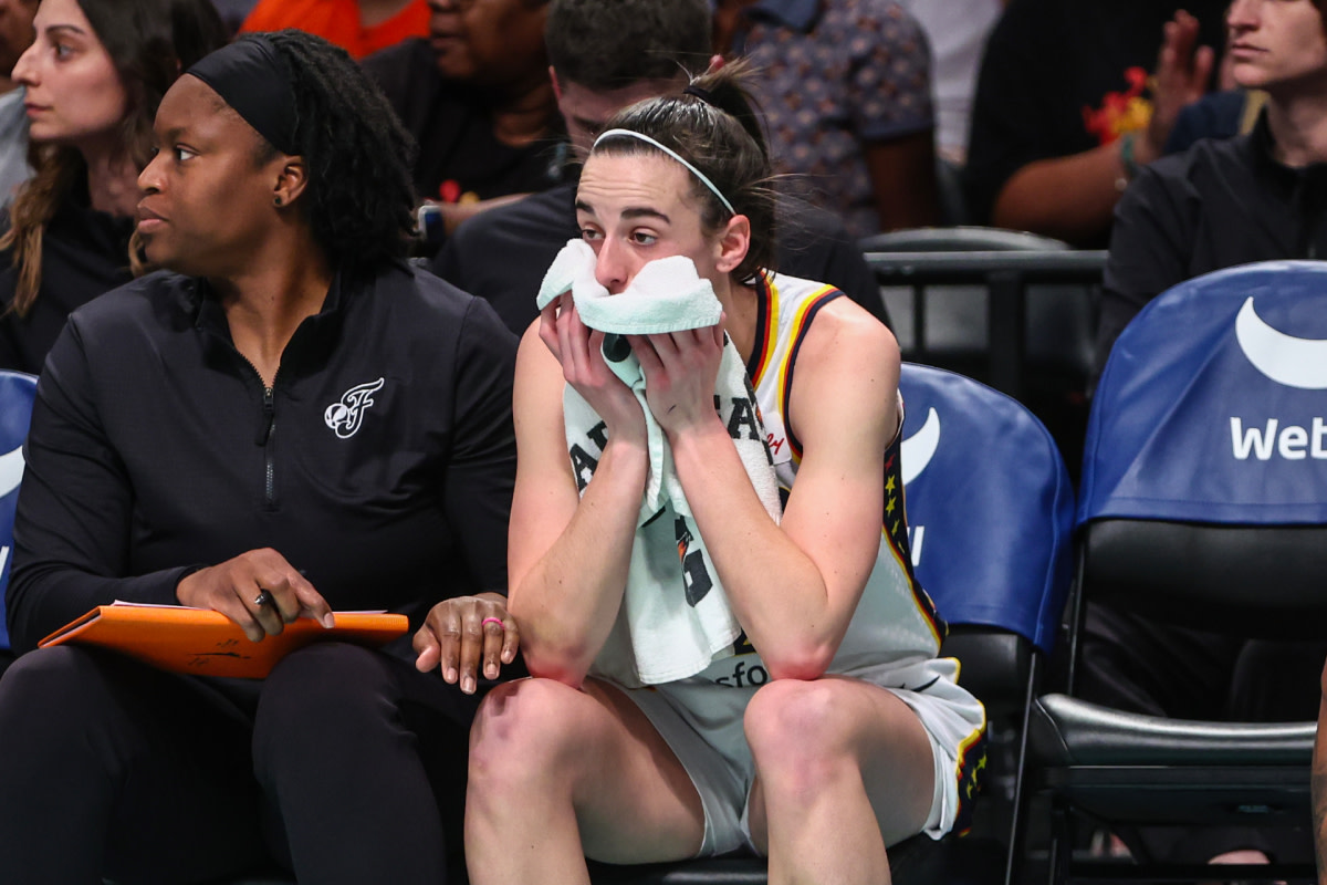Indiana Fever guard Caitlin Clark (22) watches from the bench after getting taken out during a substitution in the first quarter against the New York Liberty at Barclays Center.