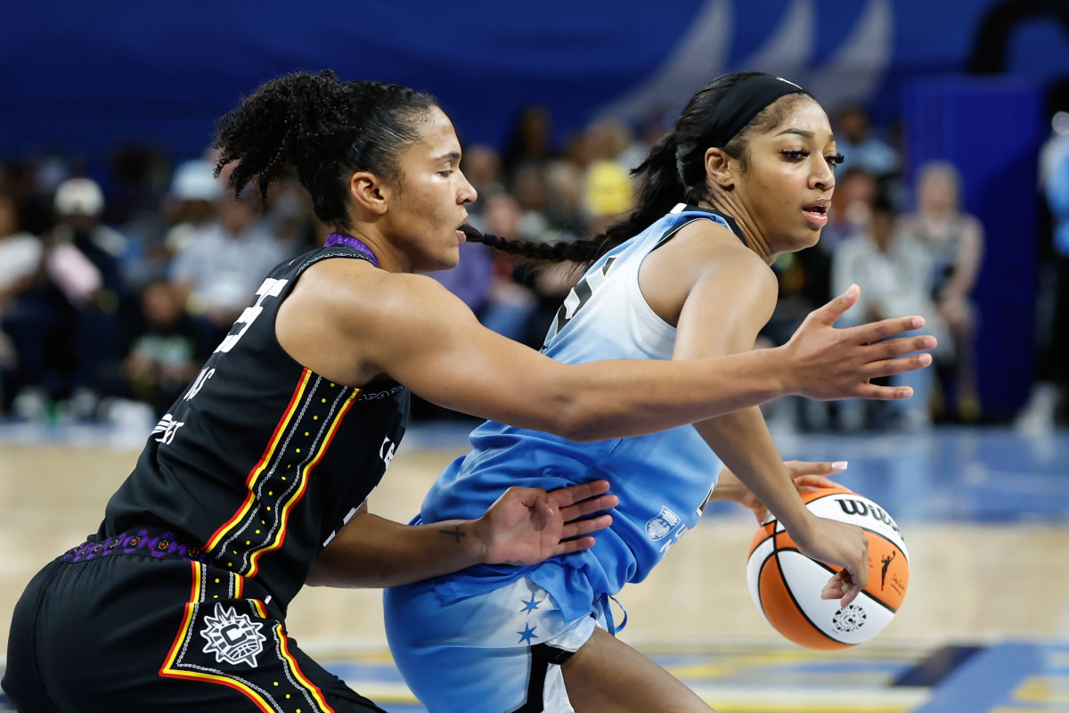 Connecticut Sun forward Alyssa Thomas (25) defends against Chicago Sky forward Angel Reese (5) during the second half of a WNBA game at Wintrust Arena.