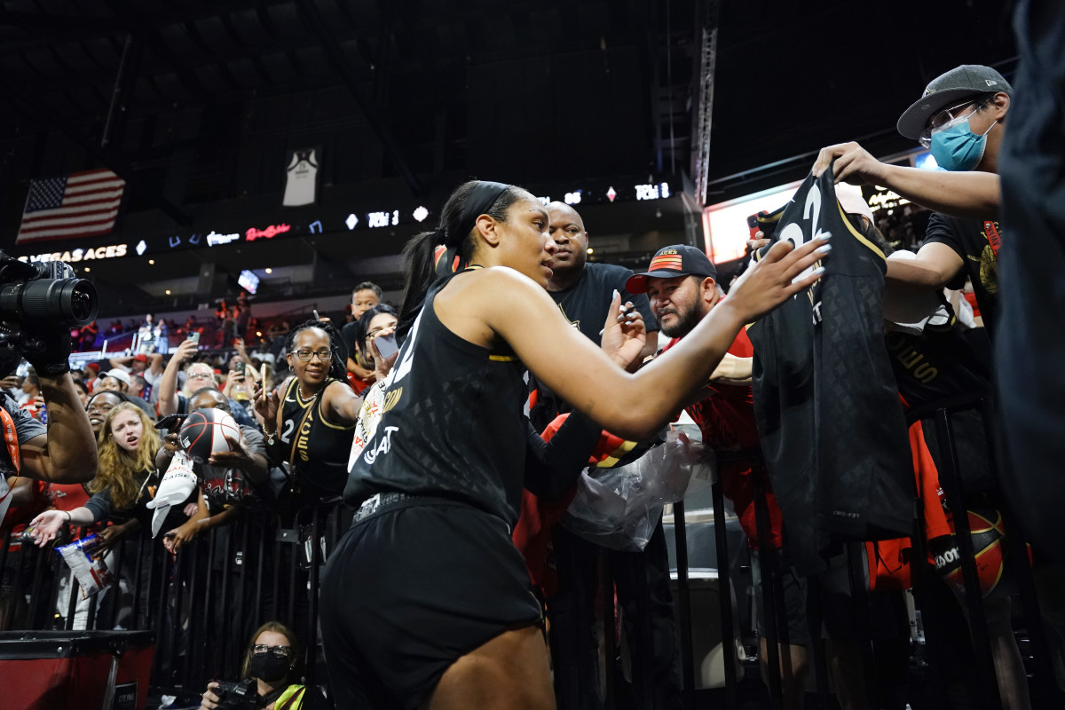 Las Vegas Aces forward Aja Wilson (22) signs a fans jersey after defeating the Connecticut Sun 85-71 in game two of the WNBA Finals at Michelob Ultra Arena.