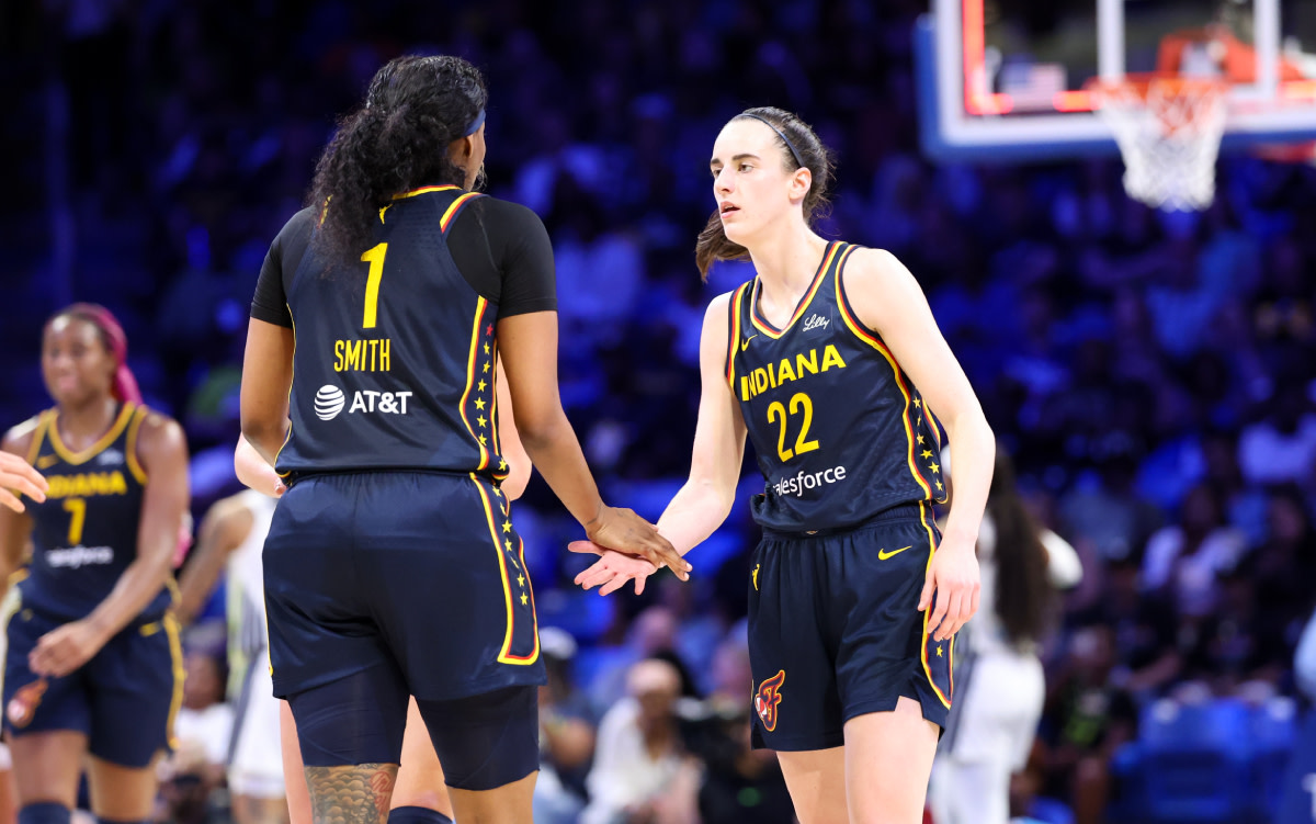 Indiana Fever guard Caitlin Clark (22) celebrates with Indiana Fever forward NaLyssa Smith (1) during the second quarter against the Dallas Wings at College Park Center.