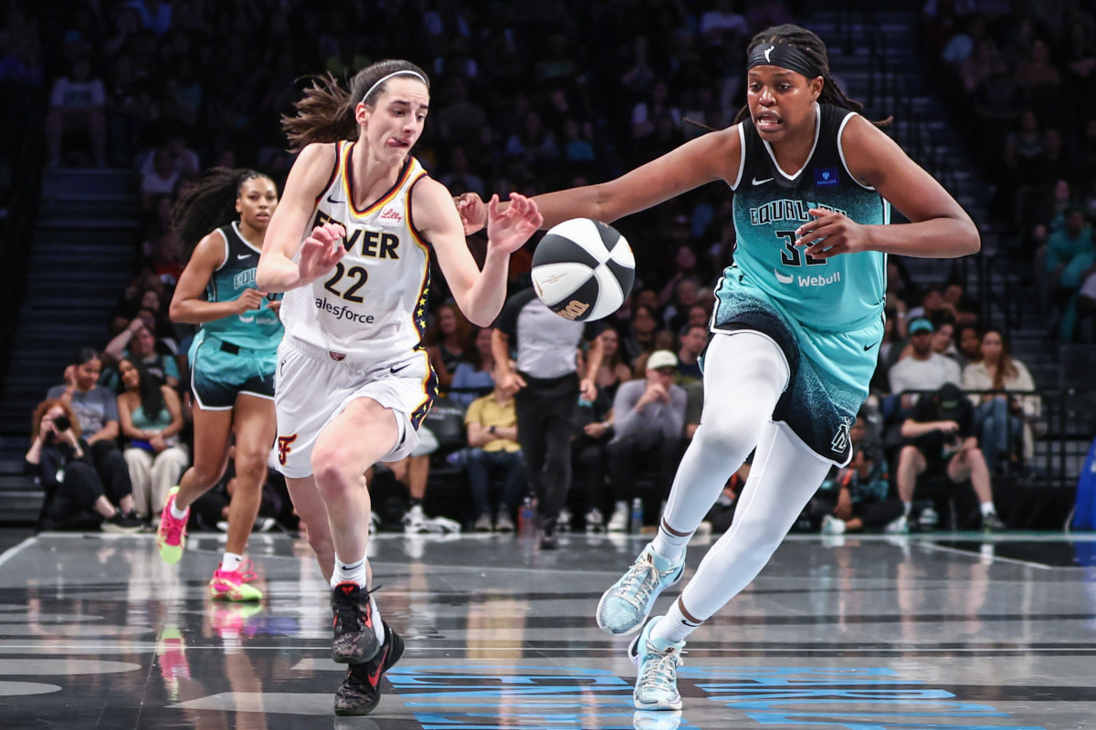 Indiana Fever guard Caitlin Clark (22) and New York Liberty forward Jonquel Jones (35) chase after a loose ball in the second quarter at Barclays Center.