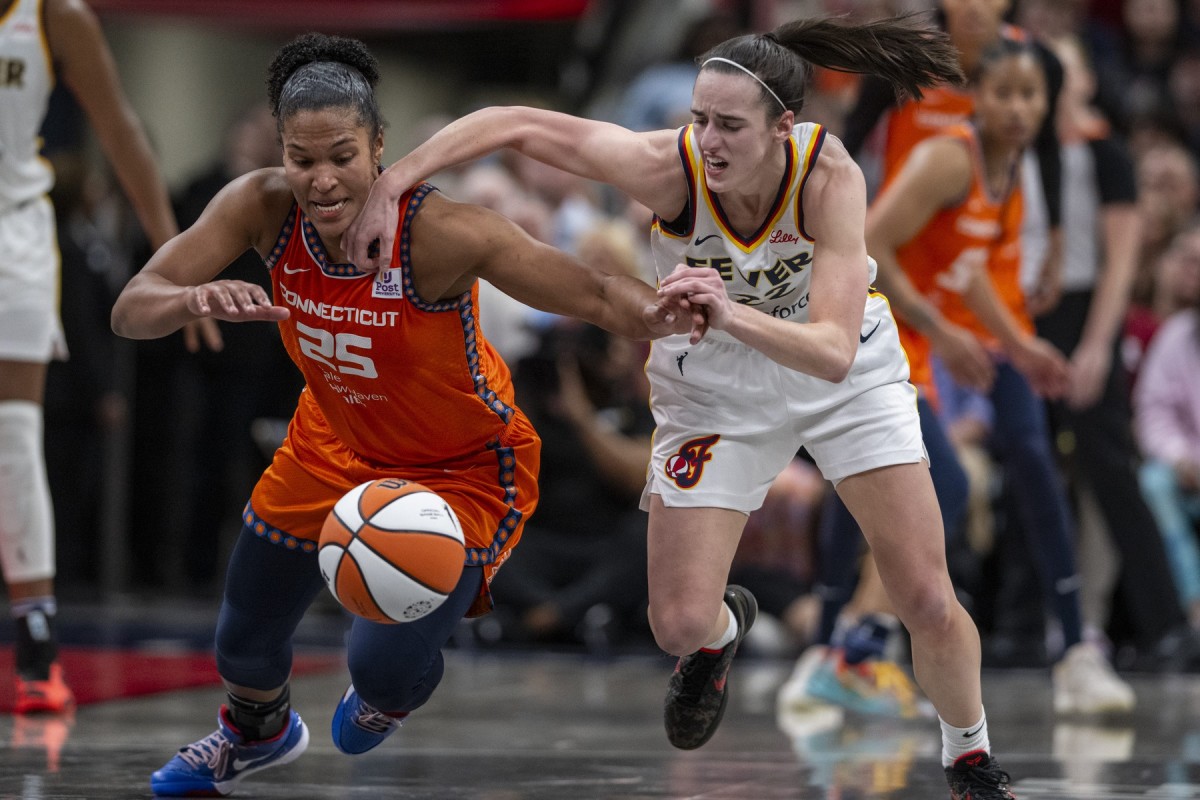 Connecticut Sun forward Alyssa Thomas (25) knocks the ball away from Indiana Fever guard Caitlin Clark (22) during the second half of an WNBA basketball game on May 20, 2024, at Gainbridge Fieldhouse.