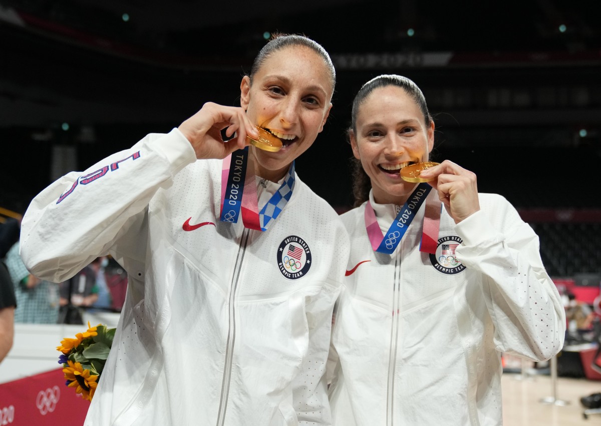 Aug 8, 2021; Saitama, Japan; United States players Diana Taurasi and Sue Bird celebrate with their gold medals after the women's basketball gold medal match during the Tokyo 2020 Olympic Summer Games at Saitama Super Arena.