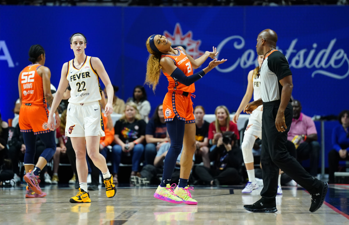 Connecticut Sun guard DiJonai Carrington (21) imitates Indiana Fever guard Caitlin Clark (22) after a foul call in the second quarter at Mohegan Sun Arena.