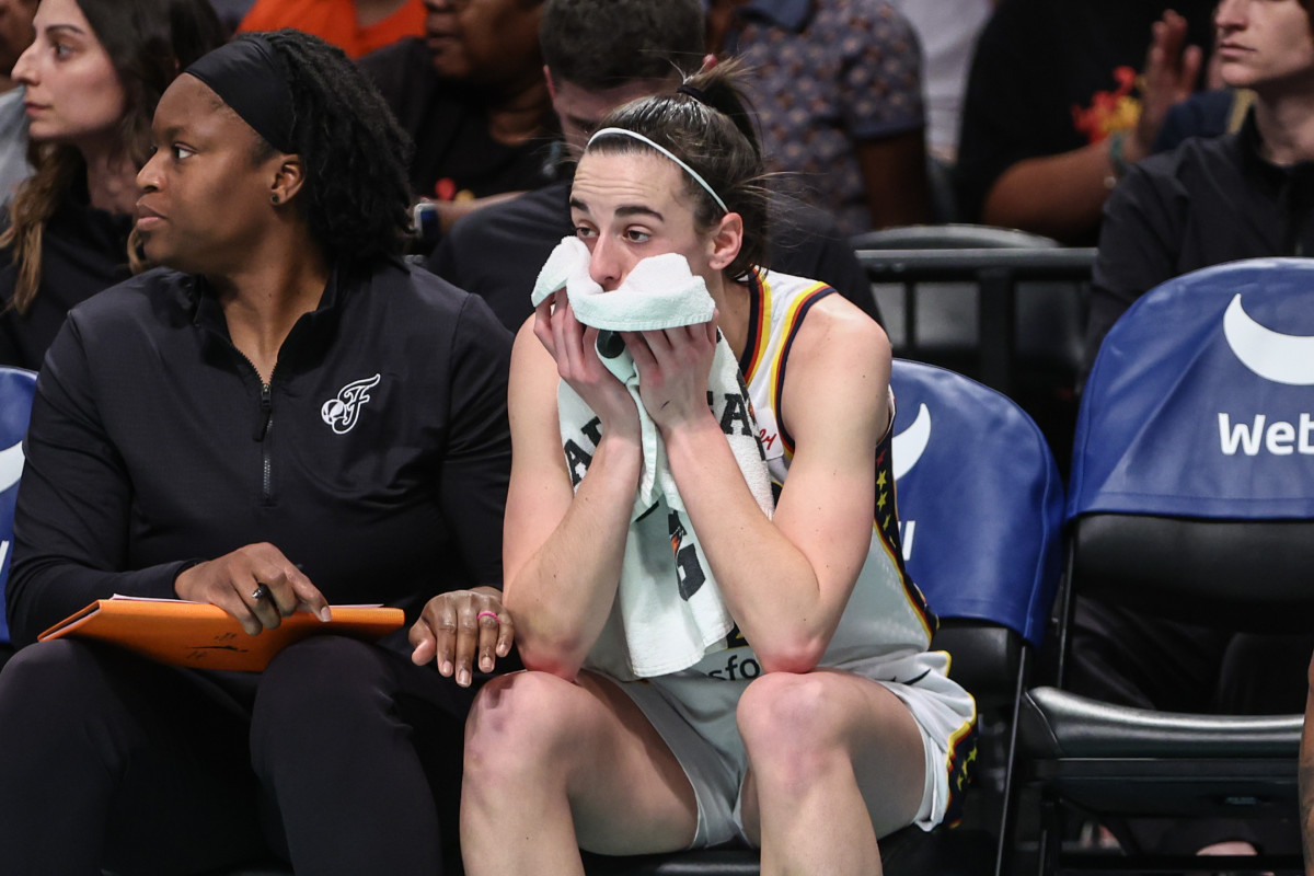 Jun 2, 2024; Brooklyn, New York, USA; Indiana Fever guard Caitlin Clark (22) watches from the bench after getting taken out during a substitution in the first quarter against the New York Liberty at Barclays Center.