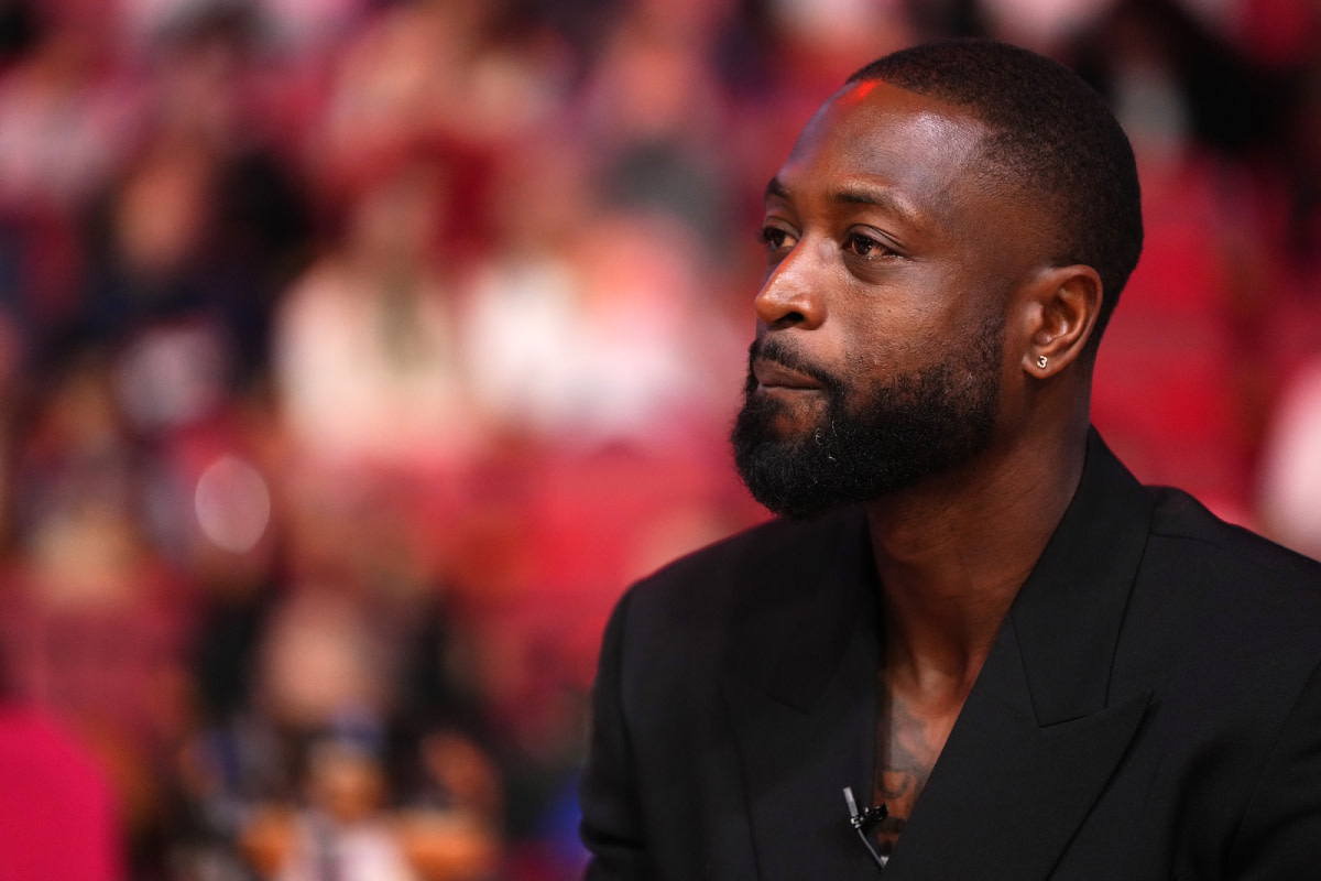 Former Miami Heat player Dwayne Wade reacts after learning a statue will be erected outside of Kaseya Center in 2025, during a special ceremony during halftime of the game between the Miami Heat and the Charlotte Hornets.