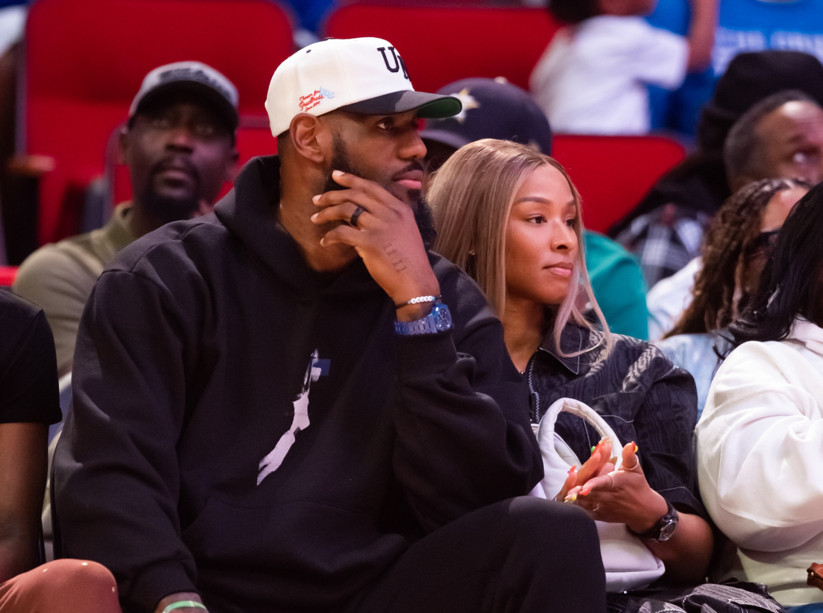 Mar 28, 2023; Houston, TX, USA; Los Angeles Lakers forward Lebron James (left) and wife Savannah James courtside during the McDonald's All American Boy's high school basketball game at Toyota Center.