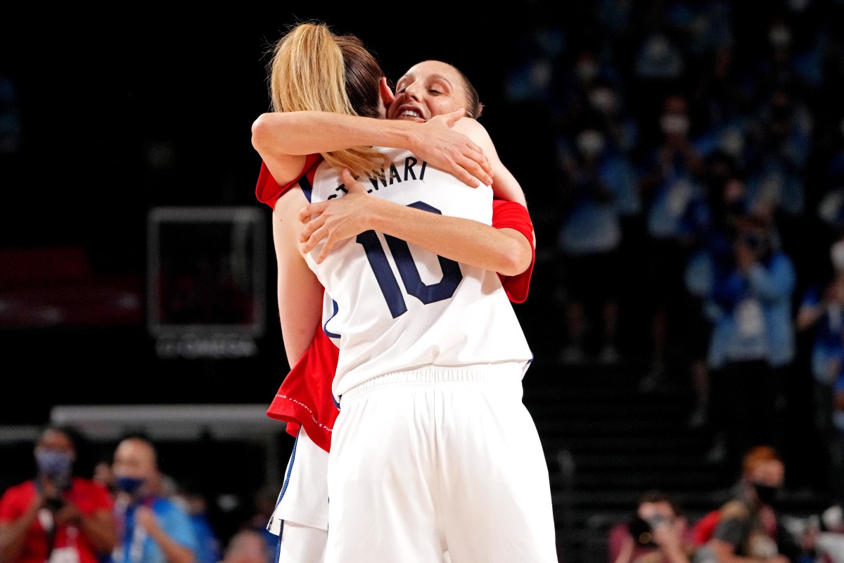 United States forward Breanna Stewart (10) and guard Diana Taurasi (12) celebrate winning the gold medal against Japan in the women's basketball gold medal match during the Tokyo 2020 Olympic Summer Games at Saitama Super Arena.