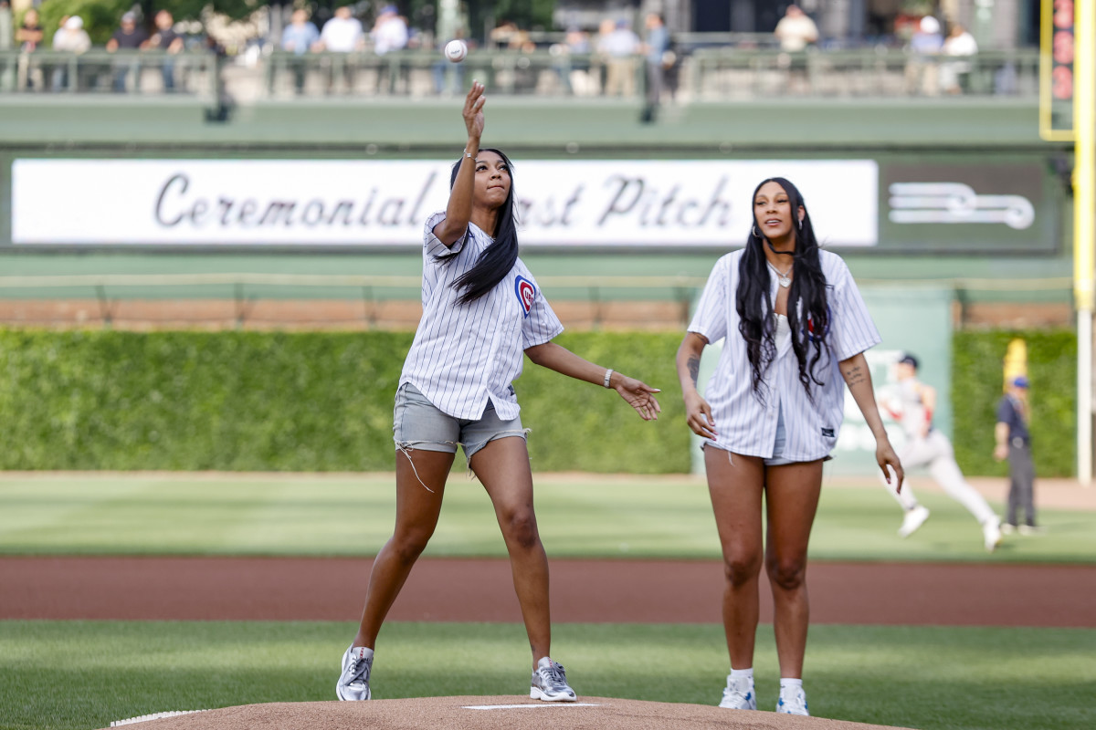 May 21, 2024; Chicago, Illinois, USA; Chicago Sky forward Angel Reese (left) and center Kamilla Cardoso (right) throw out a ceremonial first pitch before a baseball game between the Chicago Cubs and Atlanta Braves at Wrigley Field.