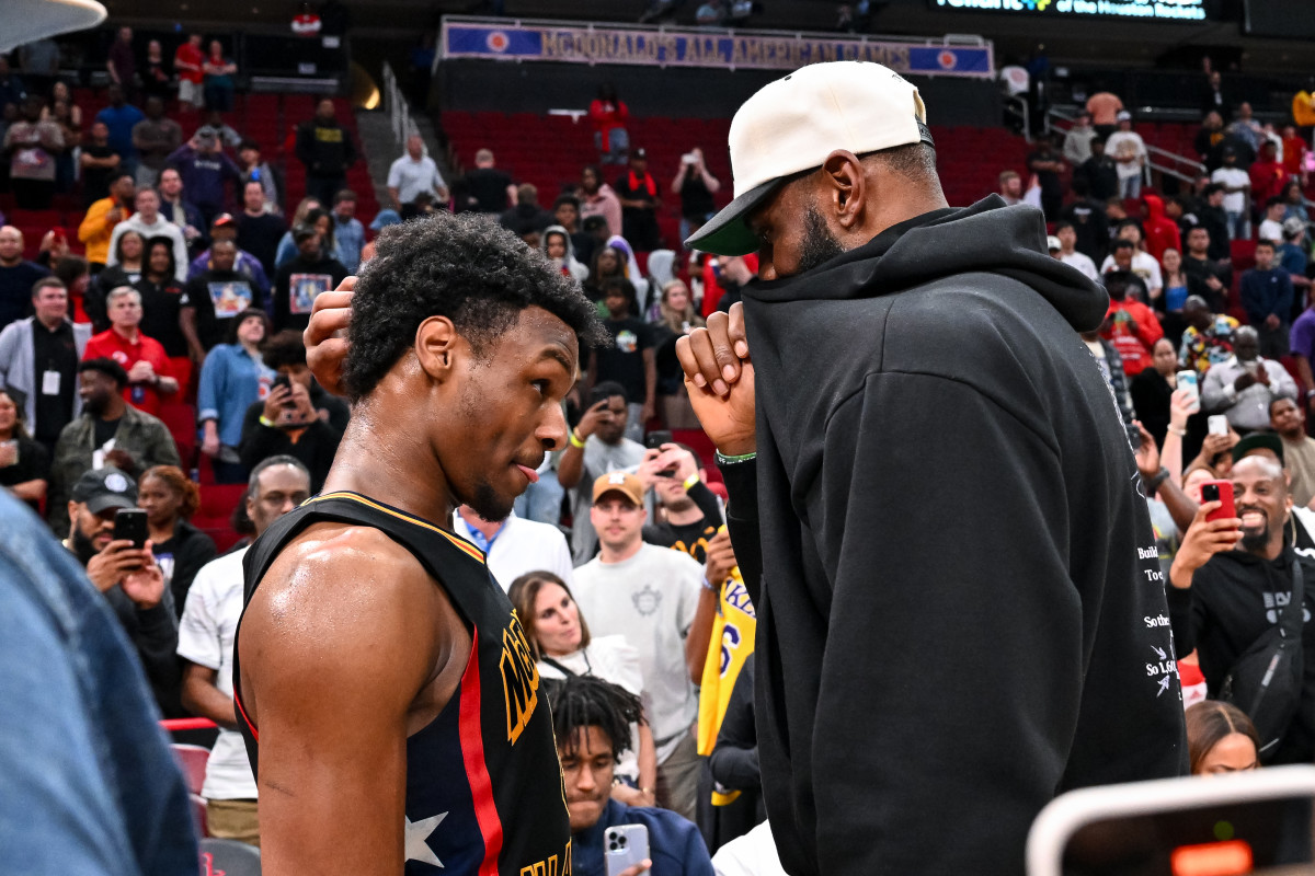 Mar 28, 2023; Houston, TX, USA; McDonald's All American West guard Bronny James (6) speaks with his father, LeBron James of the Los Angeles Lakers, after the game against the McDonald's All American East at Toyota Center.