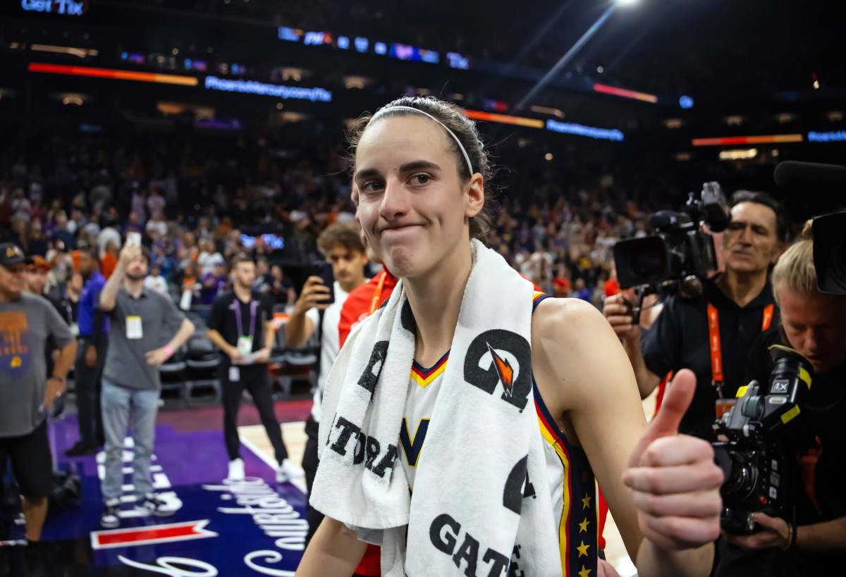 Jun 30, 2024; Phoenix, Arizona, USA; Indiana Fever guard Caitlin Clark (22) against the Phoenix Mercury during a WNBA game at Footprint Center.