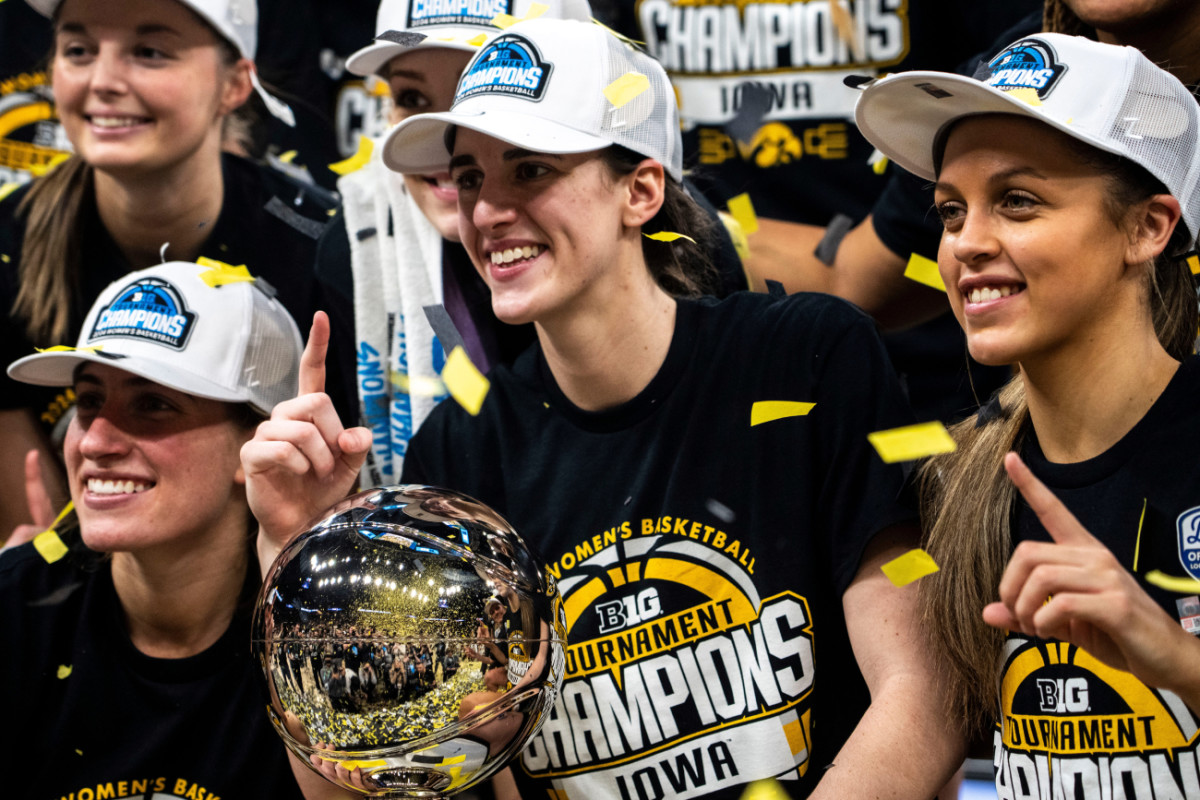 Former Iowa and Current Las Vegas Aces guard Kate Martin (20), Indiana Fever guard Caitlin Clark (22) and former Iowa guard Gabbie Marshall (24) pose for a photo after the Big Ten Tournament championship game at the Target Center on Sunday, March 10, 2024, in Minneapolis, Minn.