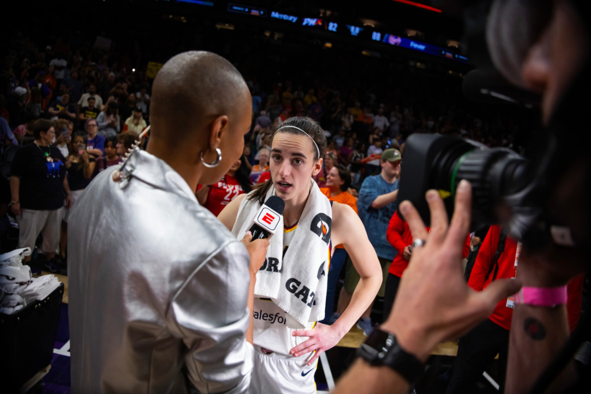 Indiana Fever guard Caitlin Clark (22) is interviewed following the game against the Phoenix Mercury during a WNBA game at Footprint Center.