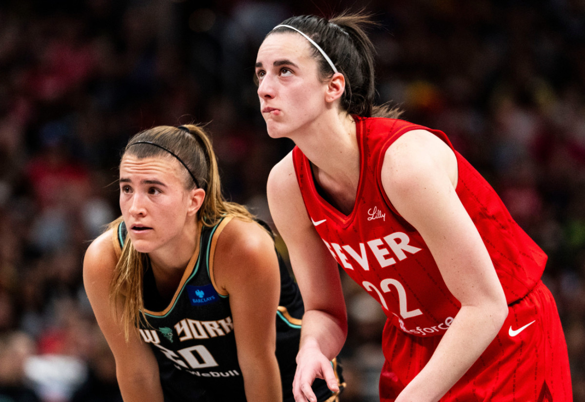 New York Liberty guard Sabrina Ionescu (20) and Indiana Fever guard Caitlin Clark (22) watch a free throw Saturday, July 6, 2024, during the game at Gainbridge Fieldhouse in Indianapolis.