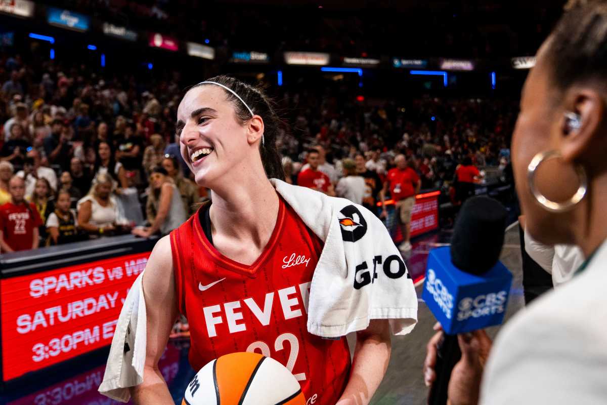 Indiana Fever guard Caitlin Clark (22) smiles in an interview after becoming the first rookie to have a triple-double Saturday, July 6, 2024, during the game at Gainbridge Fieldhouse in Indianapolis.  