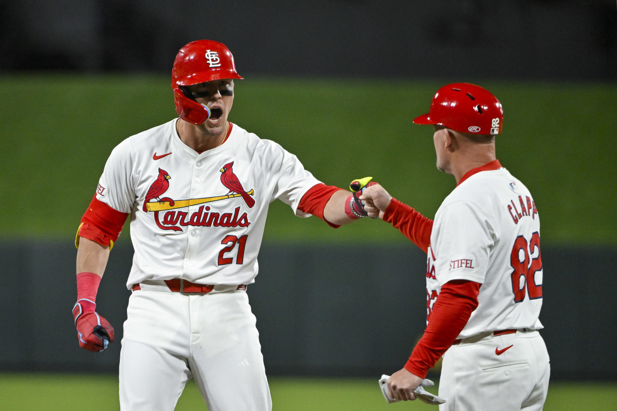 Apr 22, 2024; St. Louis, Missouri, USA; St. Louis Cardinals left fielder Lars Nootbaar (21) reacts as he celebrates with first base coach Stubby Clapp (82) after hitting a two run single against the Arizona Diamondbacks during the sixth inning at Busch Stadium.