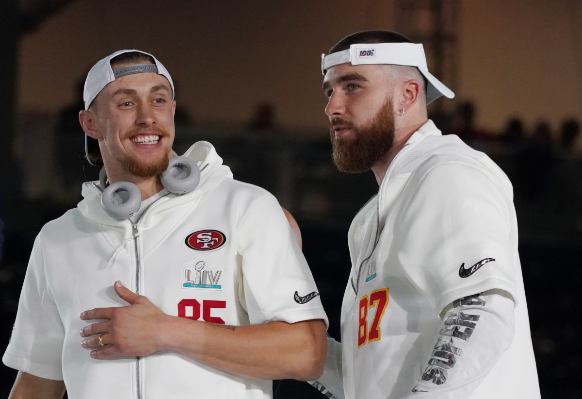 Jan 27, 2020; Miami, FL, USA; San Francisco 49ers tight end George Kittle (85) greets Kansas City Chiefs tight end Travis Kelce (87) during Super Bowl LIV Opening Night at Marlins Park.