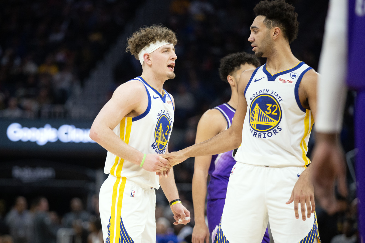 Apr 14, 2024; San Francisco, California, USA; Golden State Warriors guard Brandin Podziemski (2) gets a congratulatory handshake from forward Trayce Jackson-Davis (32) after a made basket against the Utah Jazz during the second quarter at Chase Center.