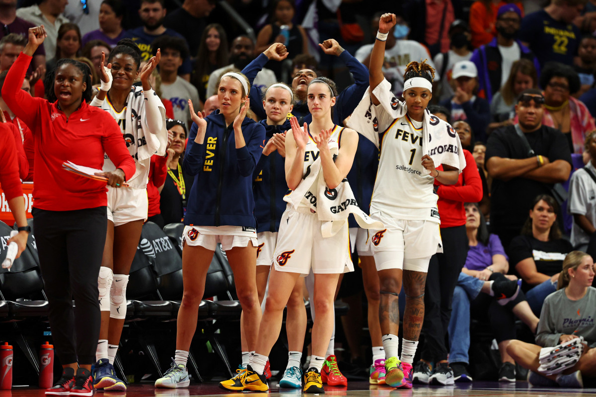 Jun 30, 2024; Phoenix, Arizona, USA; Indiana Fever guard Caitlin Clark (22) and forward NaLyssa Smith (1) react from the bench during the second half of the game against the Phoenix Mercury at Footprint Center.