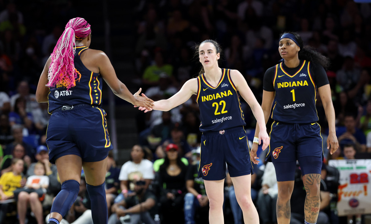 Indiana Fever guard Caitlin Clark (22) celebrates with Indiana Fever forward Aliyah Boston (7) during the second quarter against the Dallas Wings at College Park Center