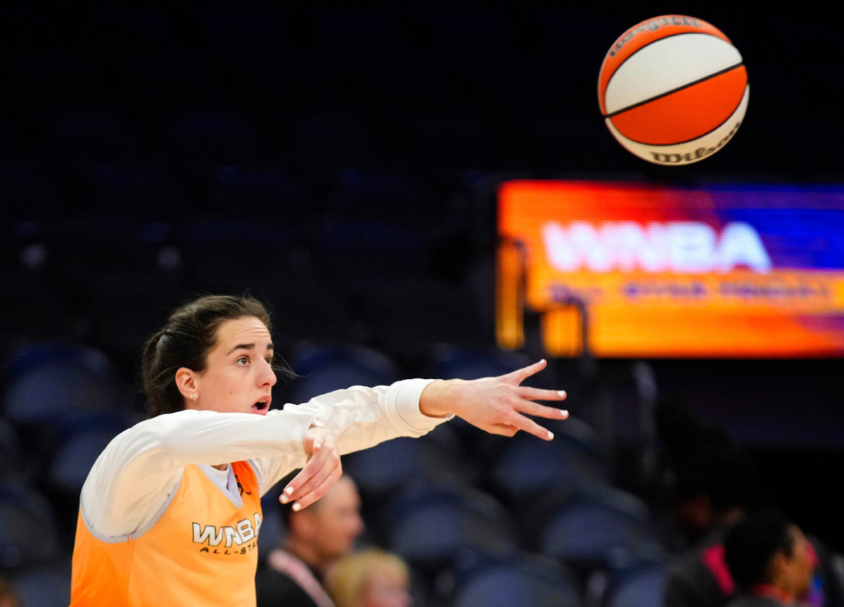 Fever guard Caitlin Clark passes across the court during WNBA All-Star practice on Media Day at the Footprint Center.