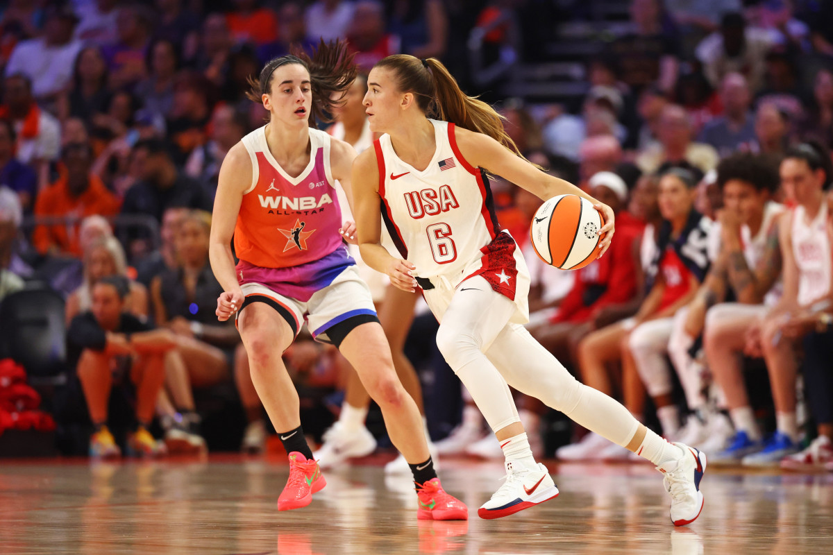 Jul 20, 2024; Phoenix, AZ, USA; USA Women's National Team guard Sabrina Ionescu (6) controls the ball as Team WNBA guard Caitlin Clark (22) defends during the first half at Footprint Center.