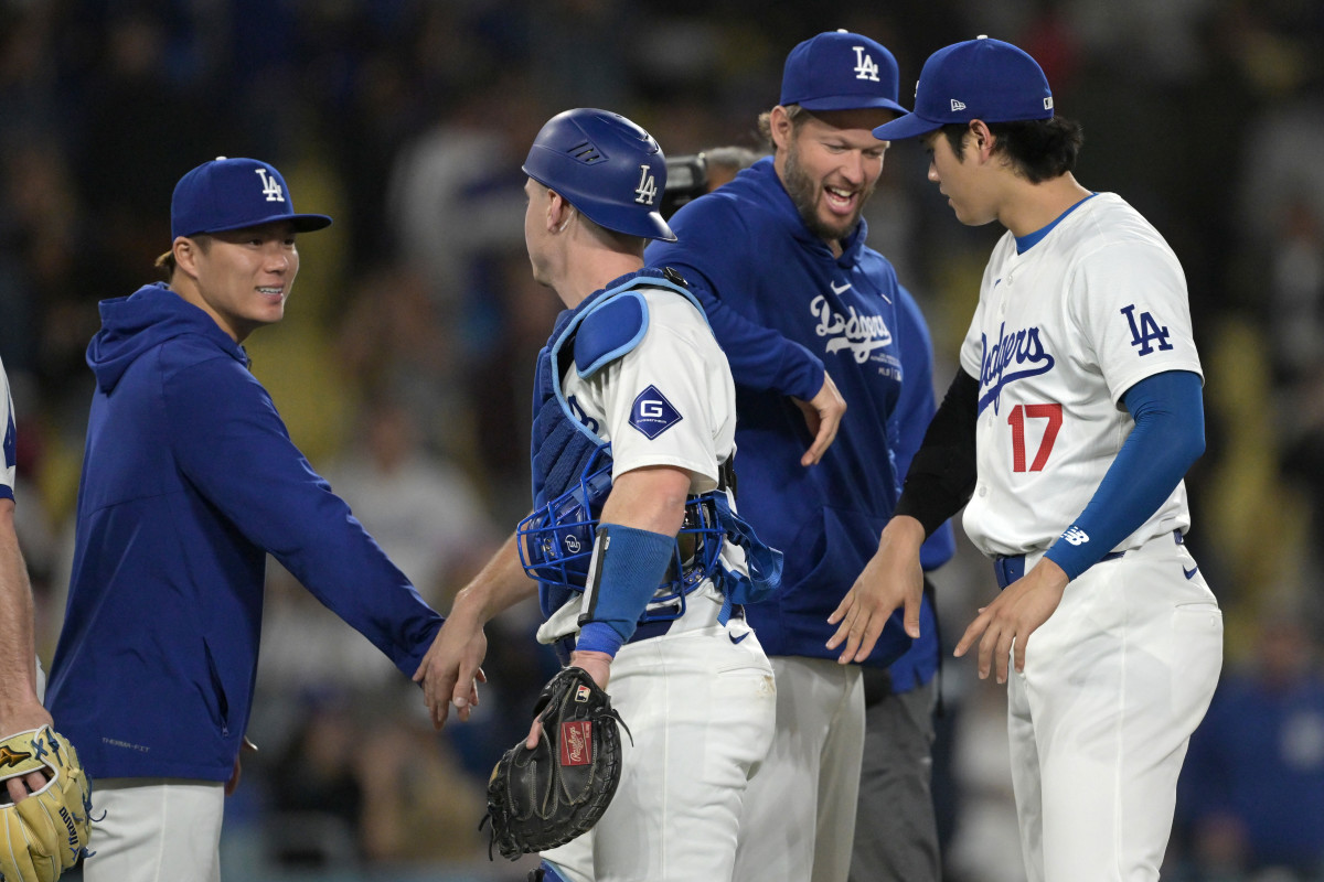 May 20, 2024; Los Angeles, California, USA; Los Angeles Dodgers starting pitcher Yoshinobu Yamamoto (18), catcher Will Smith (16), pitcher Clayton Kershaw (22) and designated hitter Shohei Ohtani (17) celebrate after the final out of the ninth inning against the Arizona Diamondbacks at Dodger Stadium