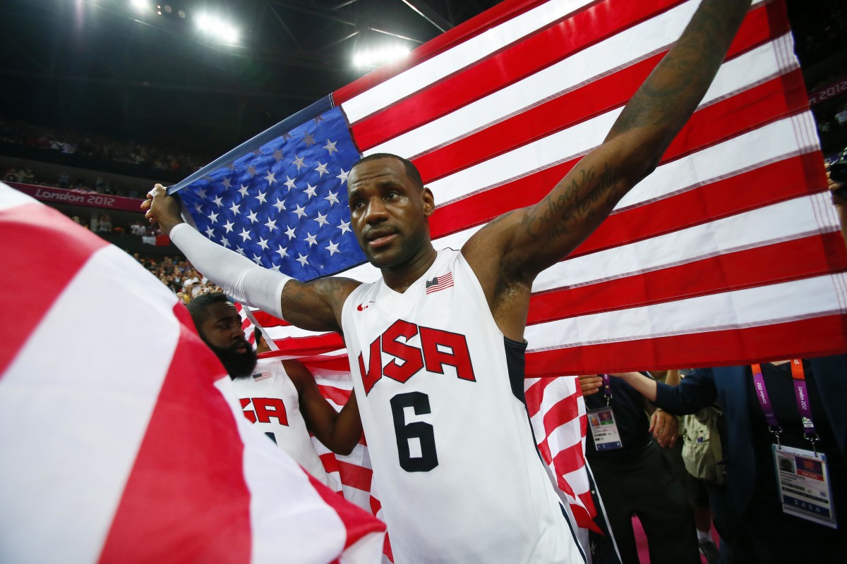 USA forward LeBron James (6) celebrates with an American flag after defeating Spain 107-100