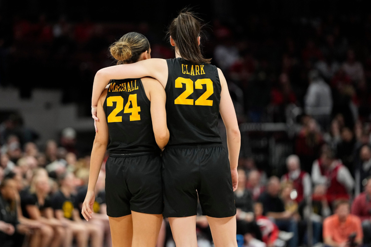 Iowa Hawkeyes guard Caitlin Clark (22) puts her arm around guard Gabbie Marshall (24) din the final seconds of the second half of the NCAA women's basketball game against the Ohio State Buckeyes at Value City Arena. Ohio State lost 83-72.