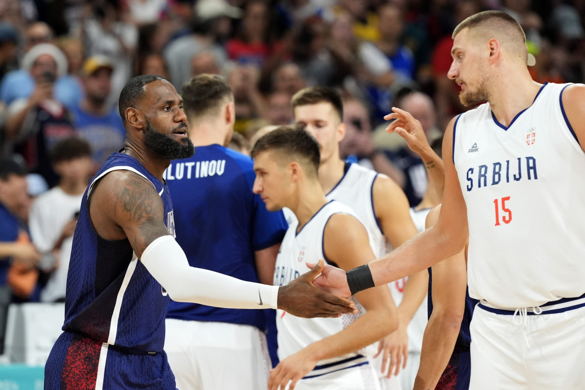 Team USA and Serbia stars LeBron James and Nikola Jokic greet each other, matching up at the 2024 Olympics.