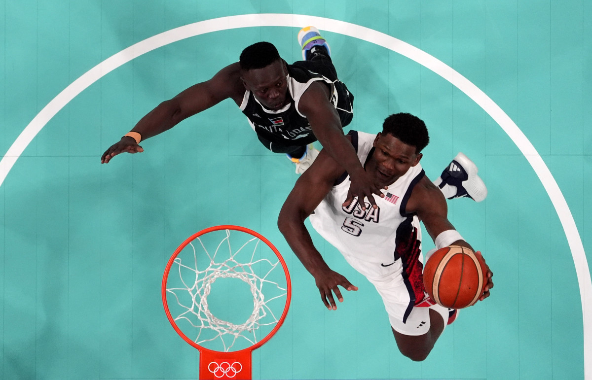 July 31, 2024; Villeneuve-d'Ascq, France; United States guard Anthony Edwards (5) shoots against South Sudan shooting guard Peter Jok (14) in the second quarter during the Paris 2024 Olympic Summer Games at Stade Pierre-Mauroy.