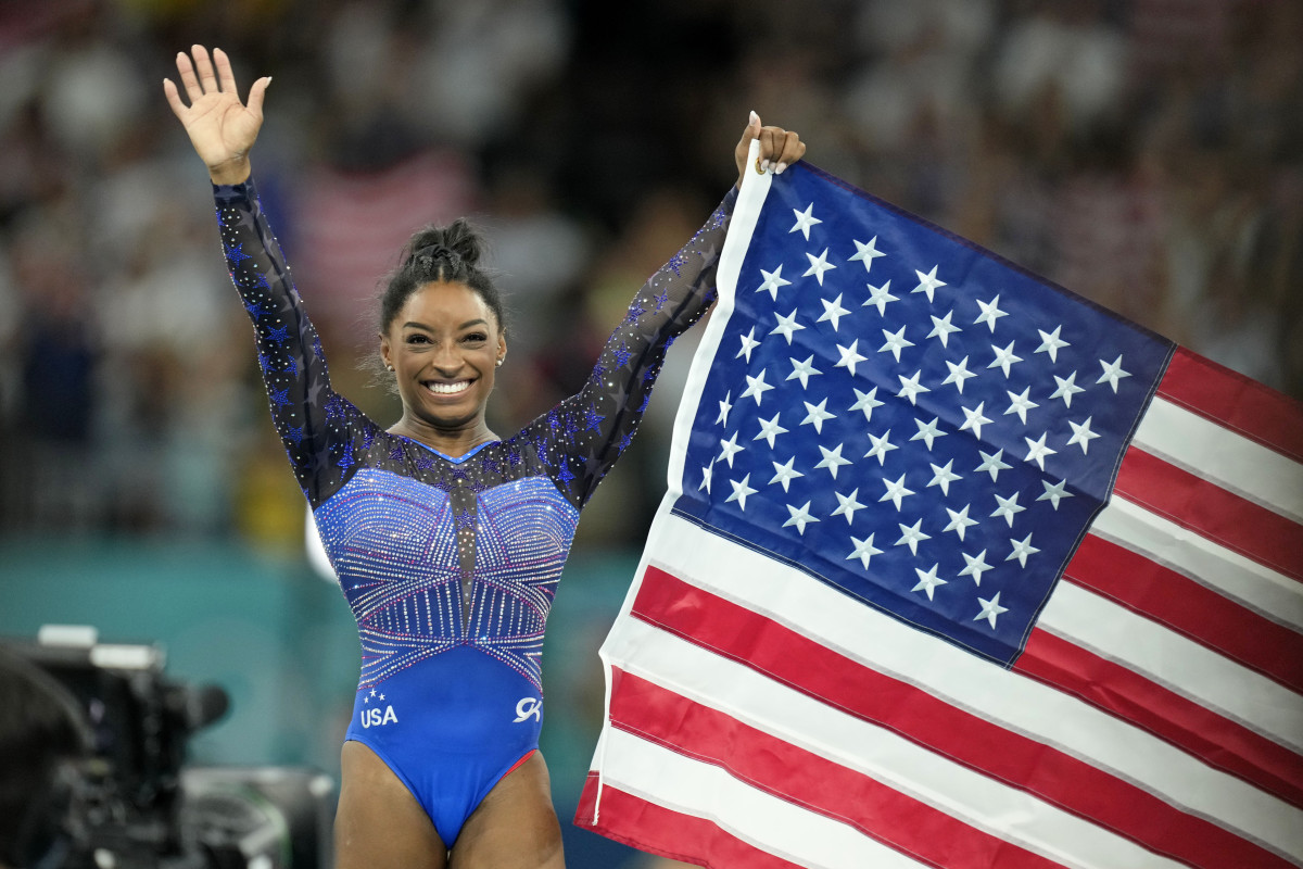 Aug 1, 2024; Paris, France; Simone Biles of the United States celebrates after winning gold in the womenís gymnastics all-around during the Paris 2024 Olympic Summer Games at Bercy Arena.