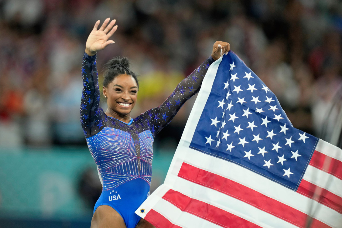 Simone Biles celebrates after winning gold in the women's gymnastics all-around during the Paris 2024 Olympic Summer Games on August 1, 2024.