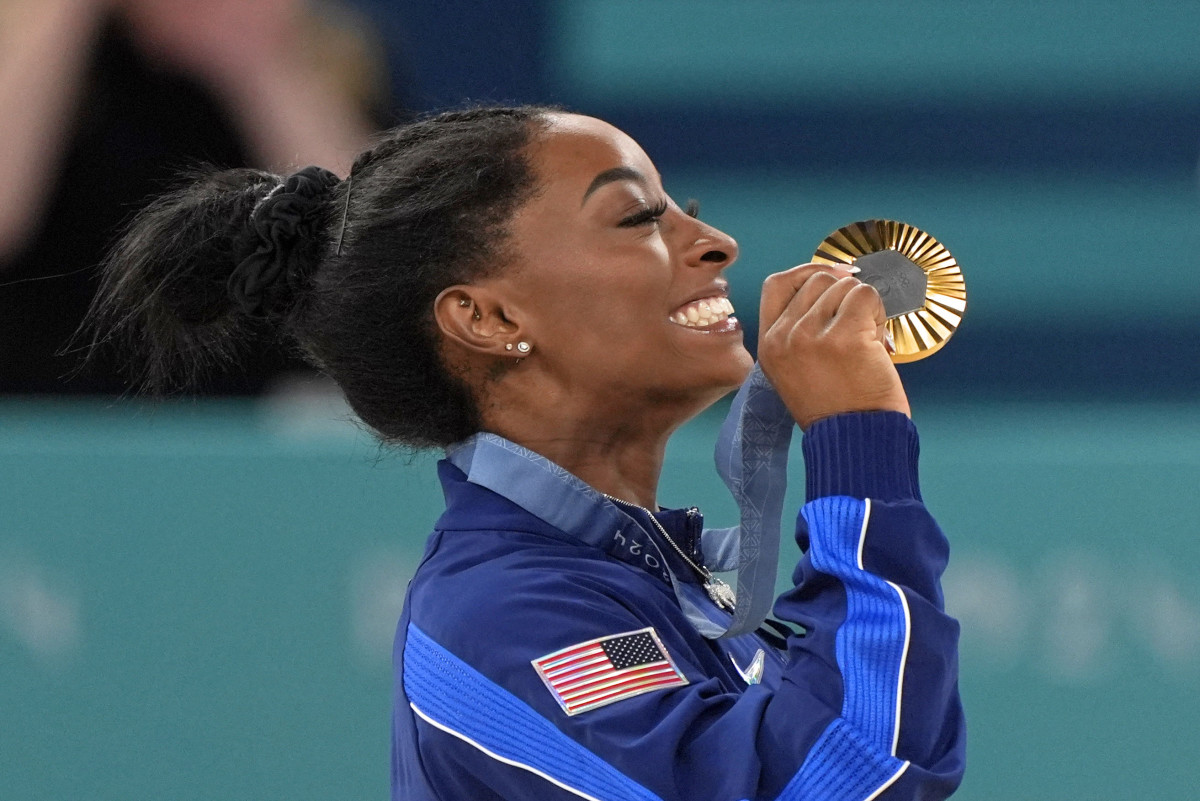 Simone Biles of the United States celebrates her gold medal in the womenís gymnastics all-around during the Paris 2024 Olympic Summer Games at Bercy Arena.