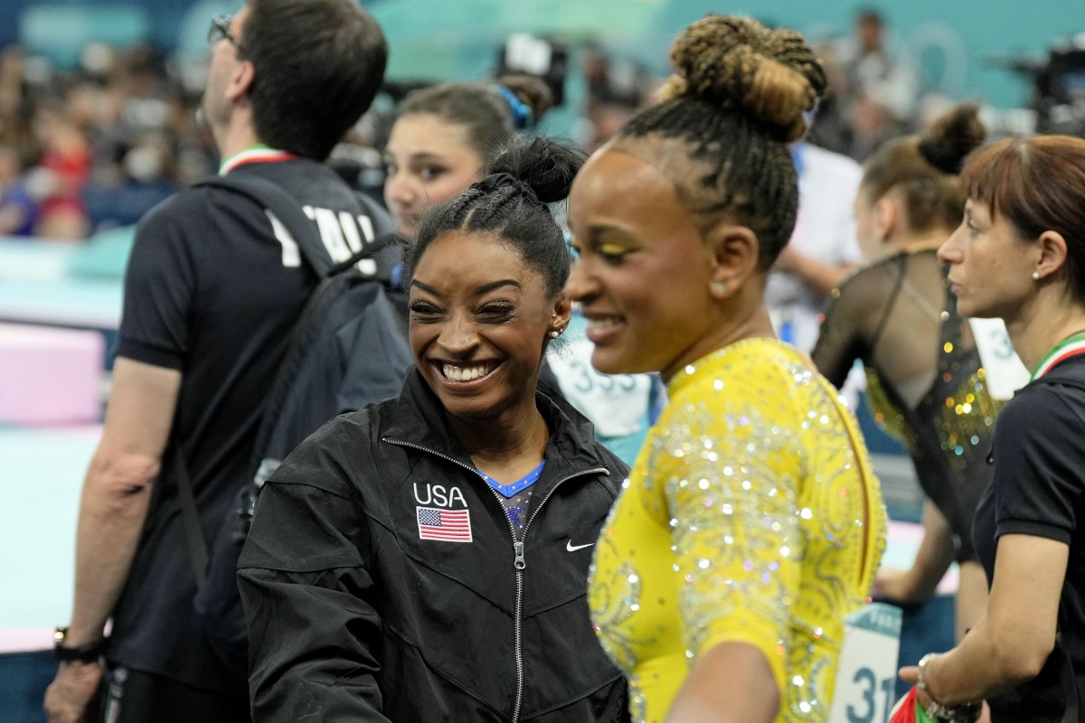 Aug 1, 2024; Paris, France; Simone Biles of the United States talks with Rebeca Andrade of Brazil during the women's gymnastics all-around during the Paris 2024 Olympic Summer Games at Bercy Arena. Mandatory Credit: Kyle Terada-USA TODAY Sports