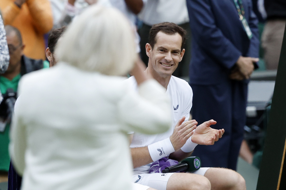 Andy Murray smiles during a ceremony honoring his Wimbledon career.