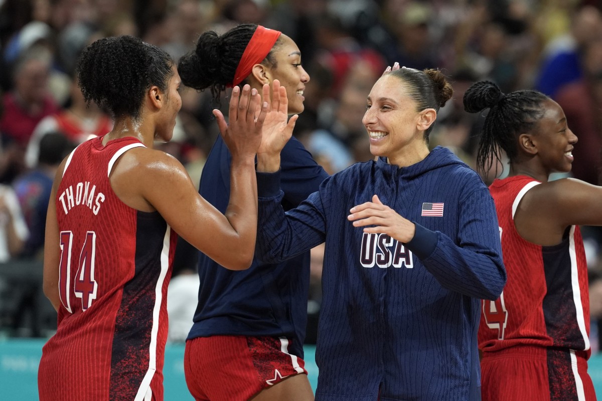 Aug 4, 2024; Villeneuve-d'Ascq, France; United States power forward Alyssa Thomas (14) and shooting guard Diana Taurasi (12) celebrate after defeating Germany in a women’s group C game during the Paris 2024 Olympic Summer Games at Stade Pierre-Mauroy.