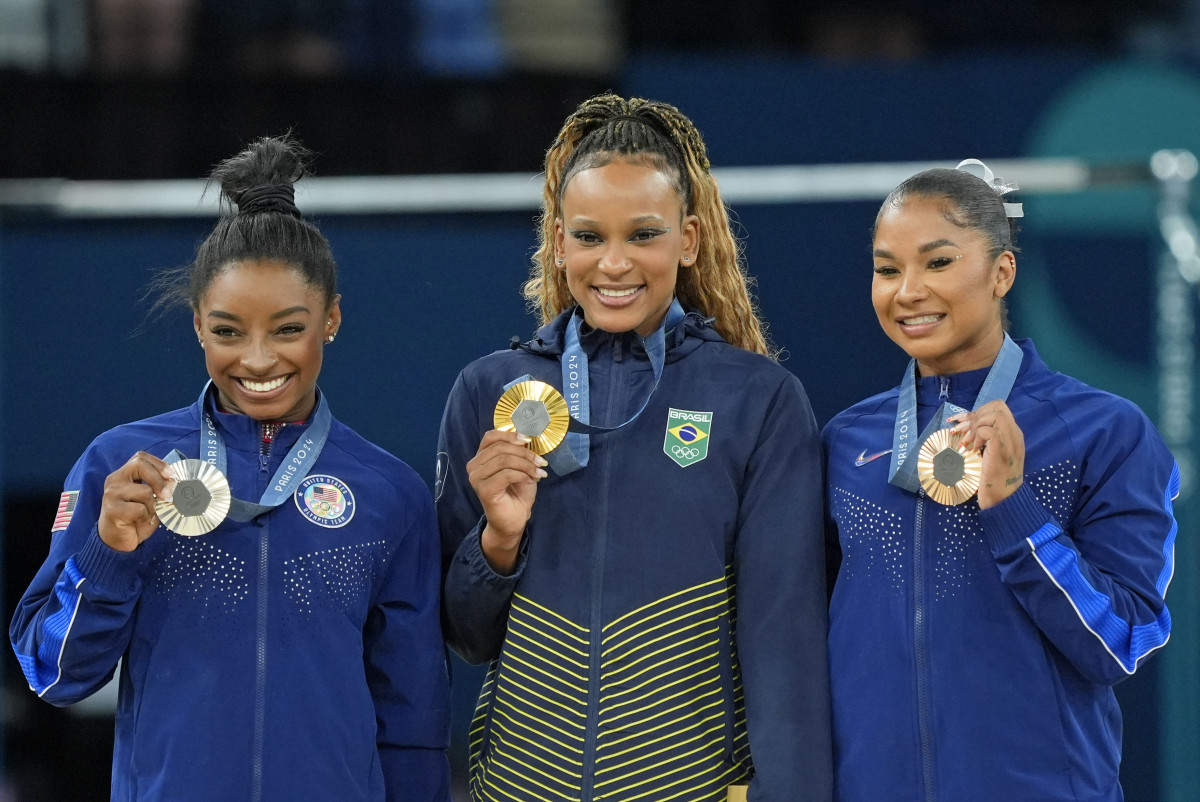 Simone Biles of the United States, Rebeca Andrade of Brazil, and Jordan Chiles of the United States with their medals on the floor exercise of the gymnastics event finals during the Paris 2024 Olympic Summer Games.