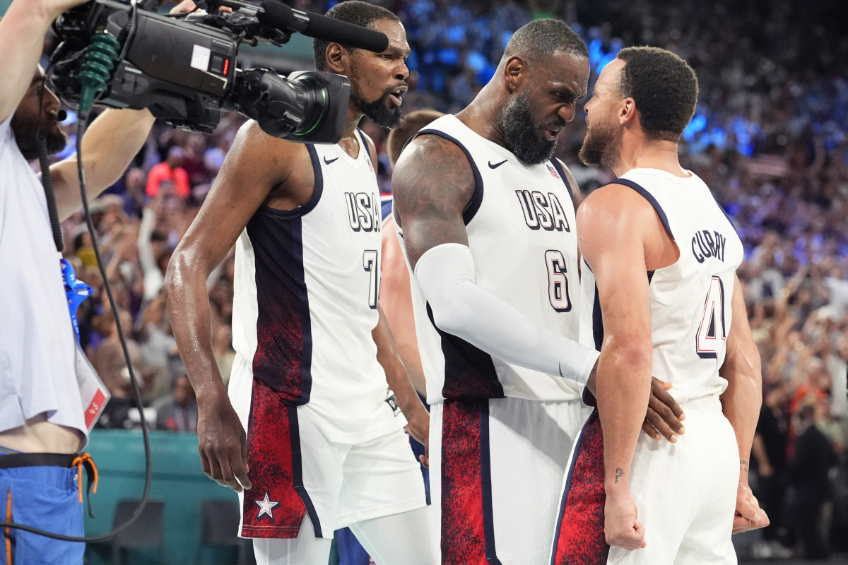 United States guard Kevin Durant (7), guard LeBron James (6) and shooting guard Stephen Curry (4) celebrate after the game against Serbia in a men's basketball semifinal game during the Paris 2024 Olympic Summer Games at Accor Arena.