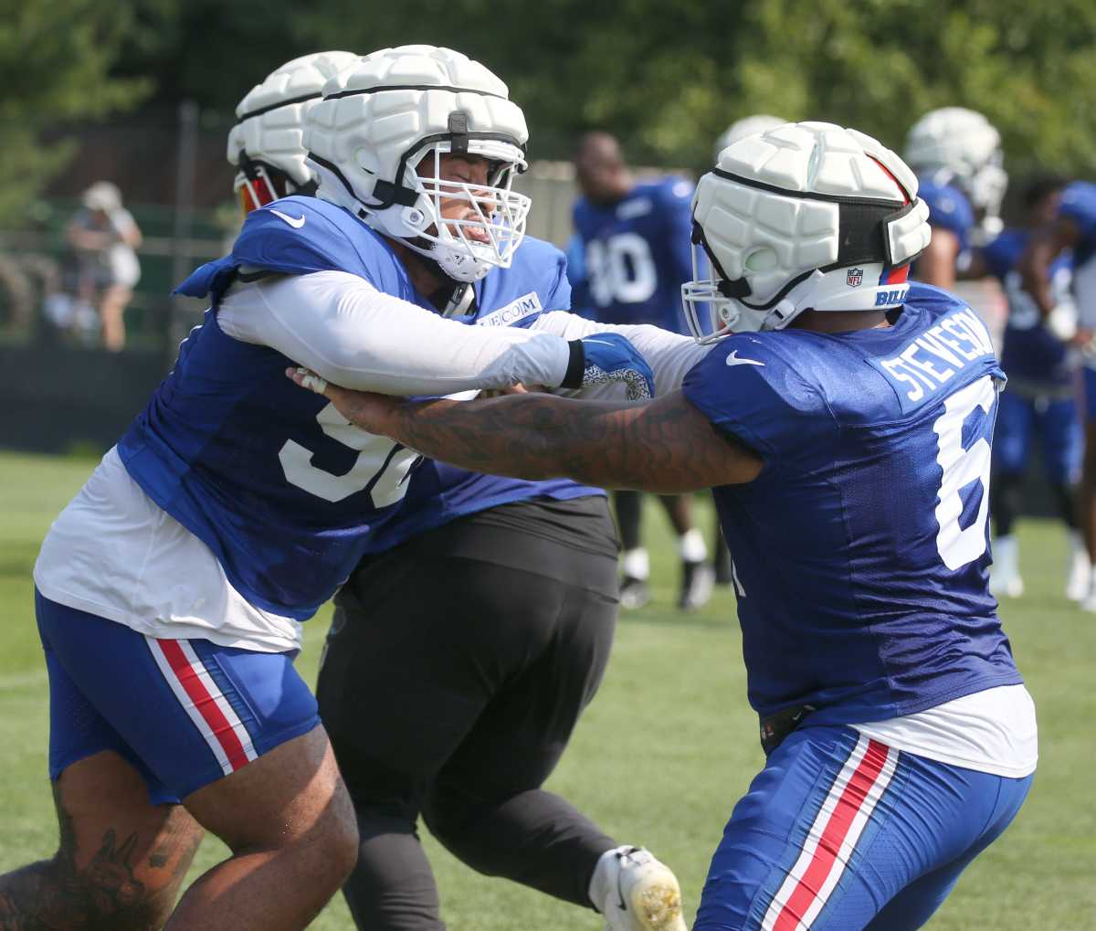 Bills defensive tackle Austin Johnson, left, breaks from the block from teammate Gable Steveson during line drills.