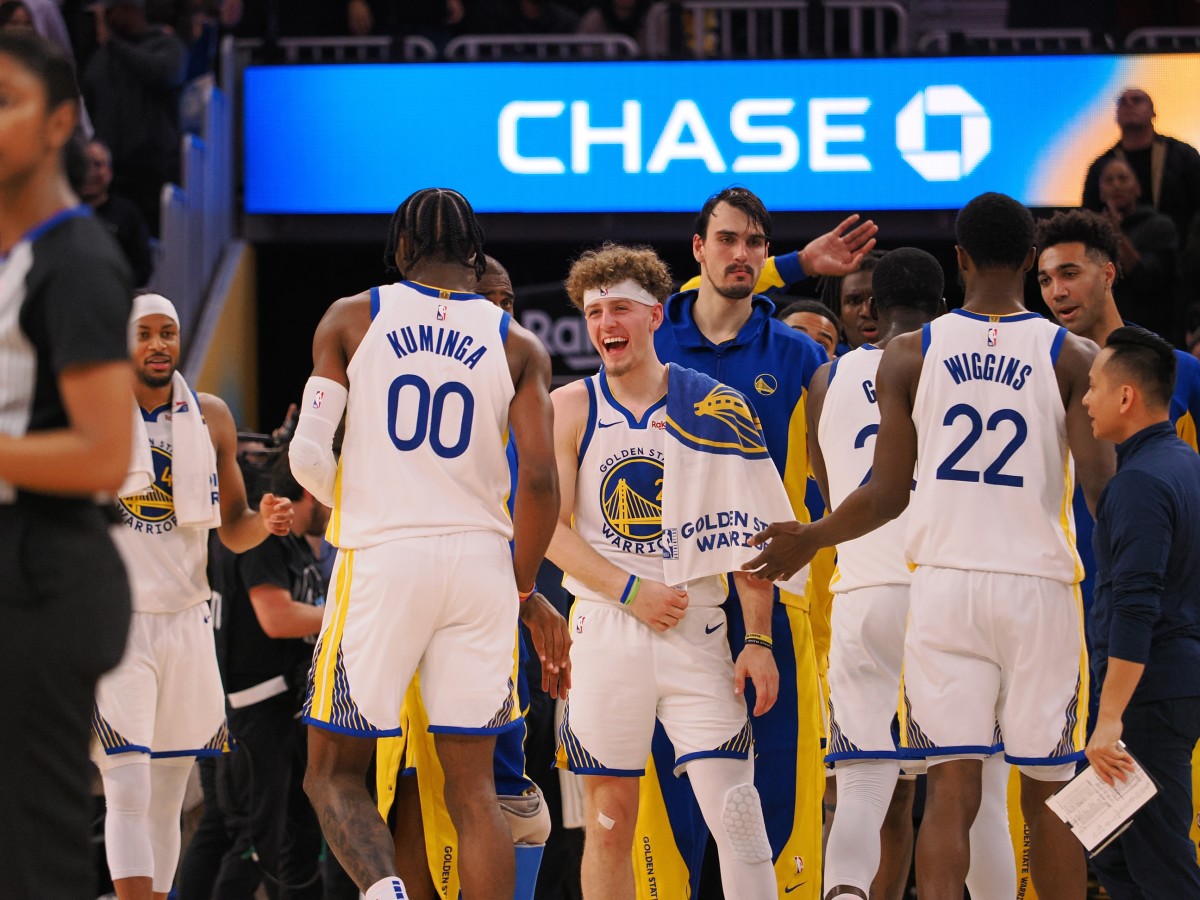 Golden State Warriors guard Brandin Podziemski (2) celebrates with forward Jonathan Kuminga (00) after a time-out is called against the Portland Trail Blazers during the fourth quarter at Chase Center.