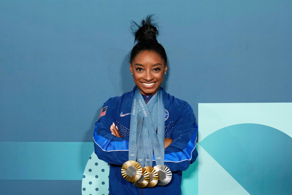 Simone Biles reacts to her viral bottle service video in Paris.