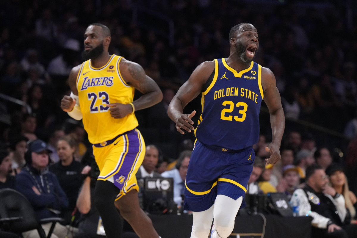 Golden State Warriors forward Draymond Green (right) and Los Angeles Lakers forward LeBron James react in the first half at Crypto.com Arena.