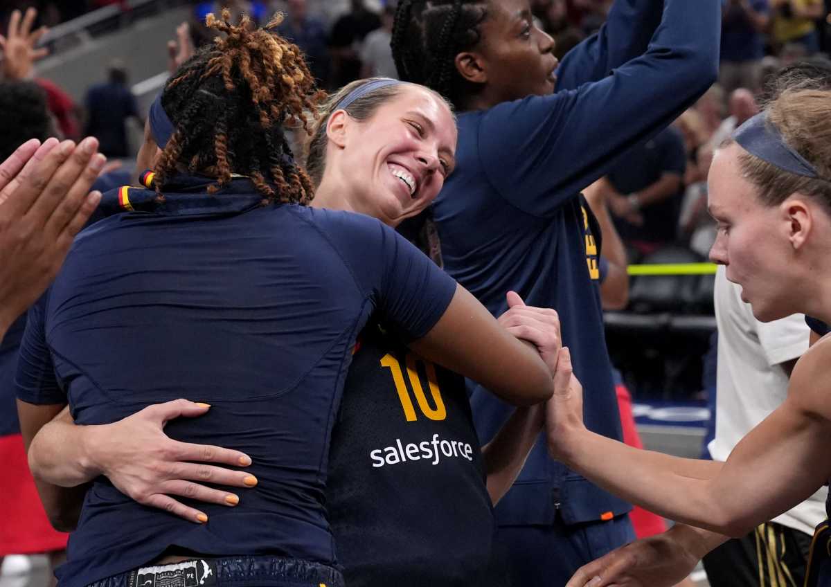 Indiana Fever forward NaLyssa Smith (1), front, hugs guard Lexie Hull (10) after they win a game against the Seattle Storm on Sunday, Aug. 18, 2024, at Gainbridge Fieldhouse in Indianapolis. The Fever defeated the Storm 92-75.