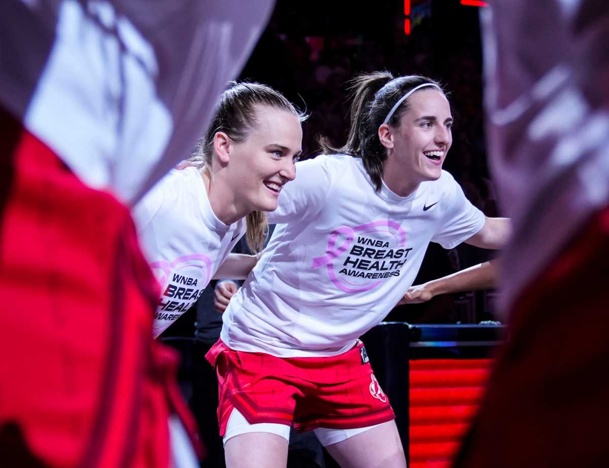 Indiana Fever guard Kristy Wallace (3) and Indiana Fever guard Caitlin Clark (22) smile in a huddle Friday, Aug. 16, 2024, before the game at Gainbridge Fieldhouse in Indianapolis.