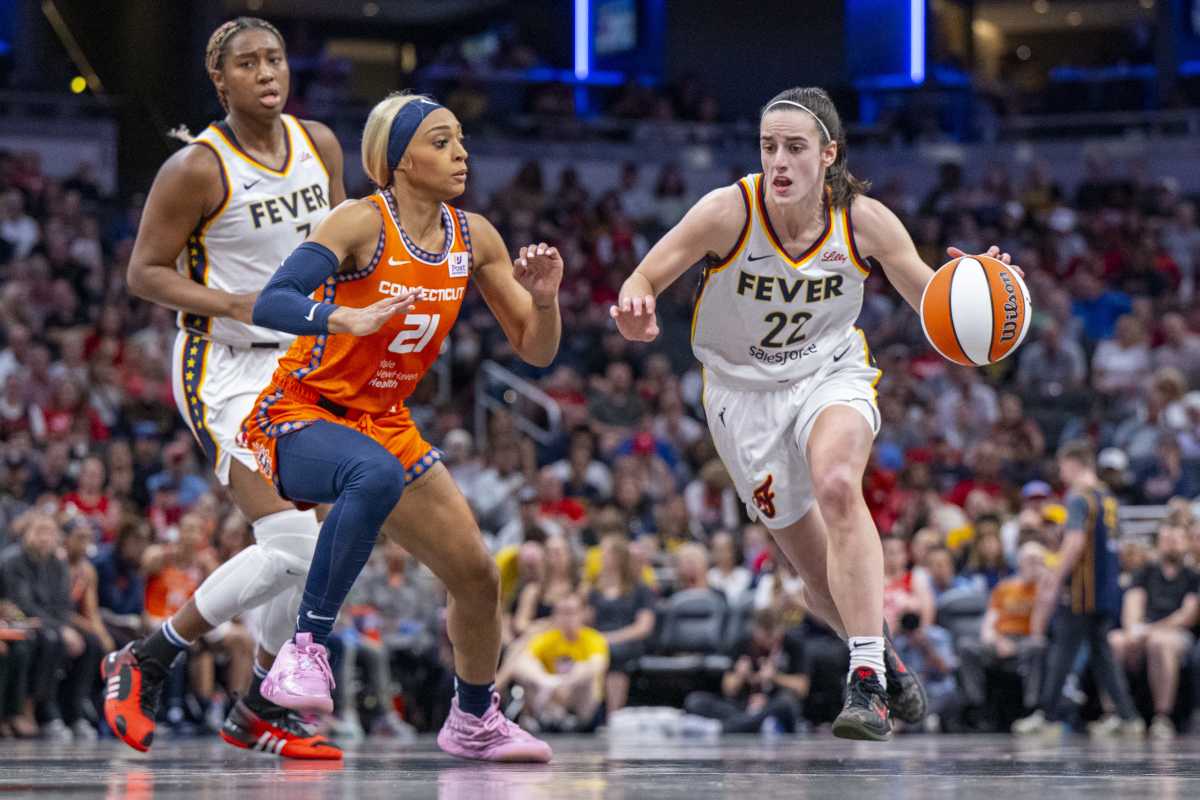 Connecticut Sun guard DiJonai Carrington defends Indiana Fever guard Caitlin Clark.