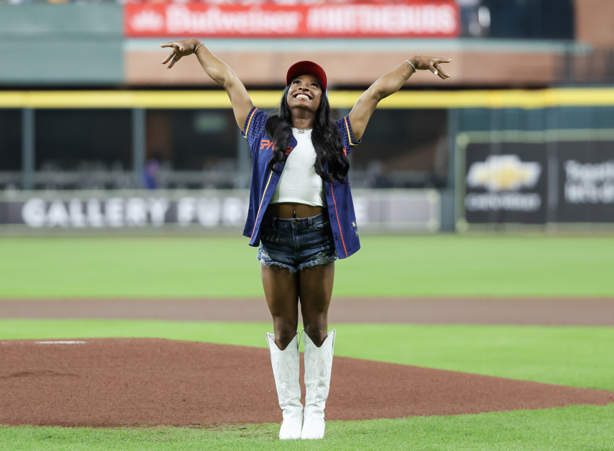 U.S. gymnast Simone Biles reacts after throwing out the ceremonial first pitch at the Houston Astros game on August 30, 2024.