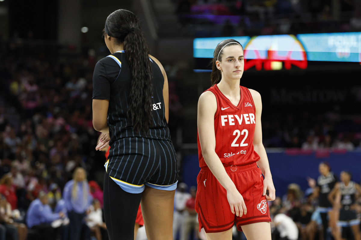 Aug 30, 2024; Chicago, Illinois, USA; Indiana Fever guard Caitlin Clark (22) walks by Chicago Sky forward Angel Reese (5) during the second half at Wintrust Arena.