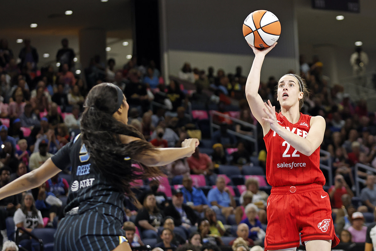 Aug 30, 2024; Chicago, Illinois, USA; Indiana Fever guard Caitlin Clark (22) shoots against Chicago Sky forward Angel Reese (5) during the first half at Wintrust Arena.