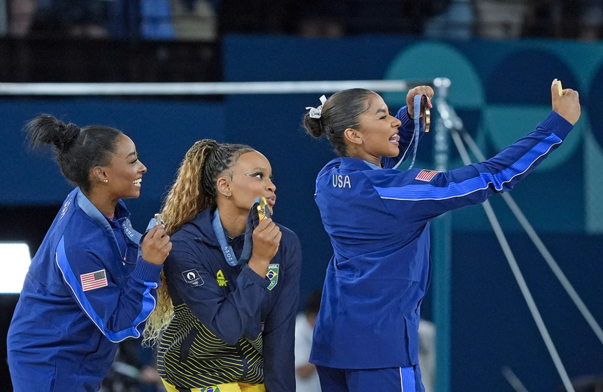 Aug 5, 2024; Paris, France; Simone Biles of the United States, Rebeca Andrade of Brazil, and Jordan Chiles of the United States with their medals on the floor exercise on day three of the gymnastics event finals during the Paris 2024 Olympic Summer Games.